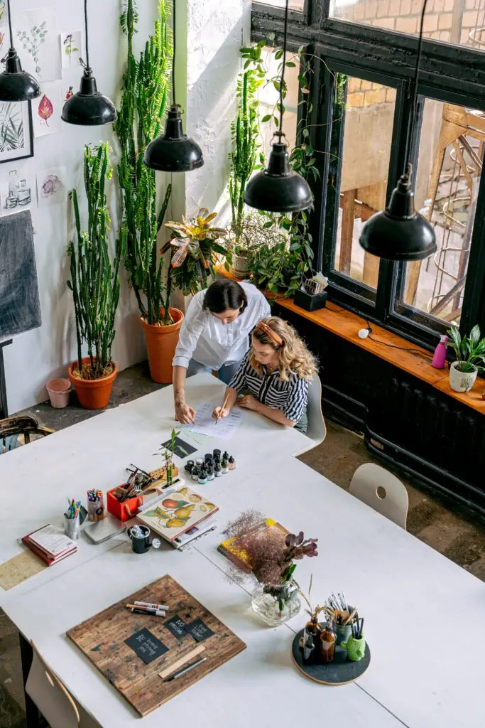 Professionals collaborating in a creative workspace, representing family business leadership, succession planning and sustainable growth across generations. Livingston James provides family business executive search services to founder-led and family-owned organisations across Scotland and the UK.