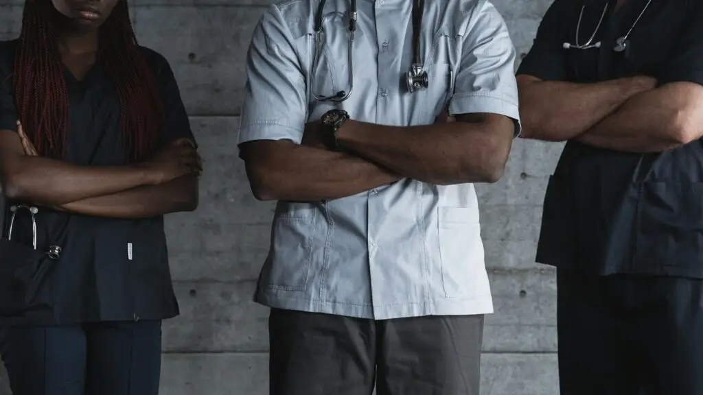 Healthcare professionals standing together in clinical uniforms, representing expert healthcare leadership and workforce excellence. Livingston James provides healthcare executive search and leadership recruitment services to healthcare organisations across Scotland and the UK.