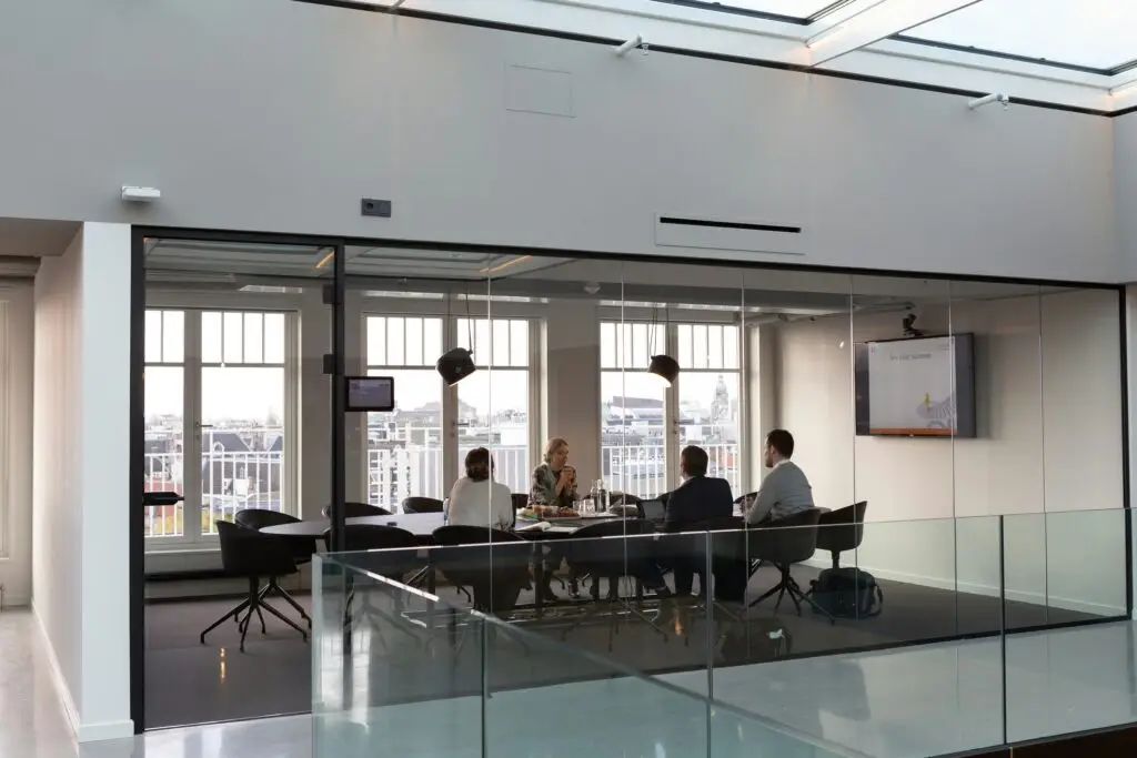 Executive leadership team meeting in a modern boardroom, reflecting strategic growth, value creation and investment performance. Livingston James provides Private Equity Executive Search services, helping portfolio companies and investors across Scotland and the UK appoint exceptional leadership talent.